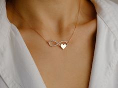 ♥ Introducing Everlasting Devotion: a pendant of love and devotion. With its graceful curves forming an endless loop, the infinity symbol represents an unbreakable bond and limitless connection. And nestled in the corner of the infinity symbol, the heart, an emblem of love and compassion, further enhances the necklace's meaning.  The romantic Rose Gold variant is featured in the photo, capturing the essence of vitality and brilliance. Yet, you can choose from three captivating gold colors, each Fine Jewelry Infinity Necklaces For Wedding, Fine Jewelry Infinity Necklace For Wedding, Infinity Shape Wedding Necklaces In Fine Jewelry Style, Infinity Shape Fine Jewelry Necklaces For Wedding, Delicate Infinity Necklace For Anniversary, Gold Infinity Necklace For Anniversary, Wedding Jewelry For Valentine's Day With Infinity Design, Valentine's Day Wedding Jewelry With Infinity Shape, 14k Gold Infinity Necklace For Wedding