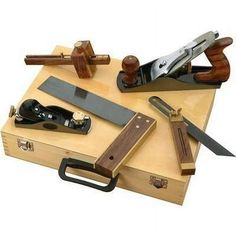 several different types of knives on a wooden box