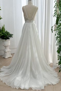 a wedding dress on display in front of a window