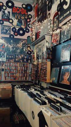 an old record store with records hanging from the ceiling and posters on the wall above it