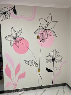 a wall with flowers painted on it in a room that has marble floors and walls