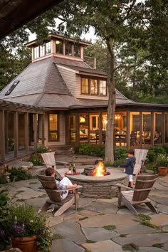 an outdoor fire pit with chairs around it