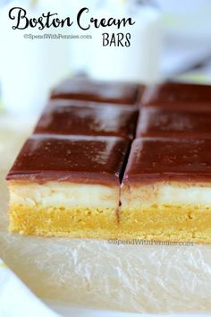 boston cream bars are stacked on top of each other and ready to be cut into pieces