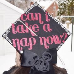 a girl wearing a graduation cap that says can i take a nap now?