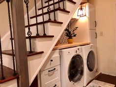 a washer and dryer are under the stairs