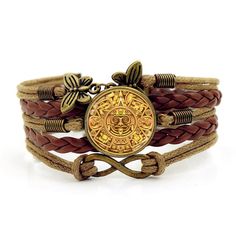 a brown leather bracelet with an ancient coin on the front and gold tone metal clasp