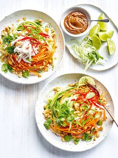 two white plates filled with food on top of a table