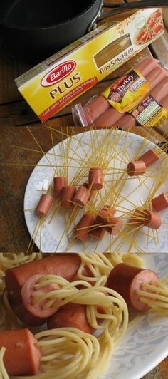 some hot dogs and spaghetti on a plate with other food items around the table in front of them