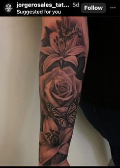 a woman's arm with flowers and butterflies on it