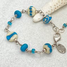 Handmade Blue Sterling Silver Beaded Bracelets, Blue Wire Wrapped Bracelets, Unique Blue Wire-wrapped Bracelets, Unique Blue Wire Wrapped Bracelets, Turquoise Czech Glass Bracelets With Large Beads, Unique Turquoise Czech Glass Beaded Bracelets, Handmade Blue Beaded Bracelets With Czech Glass, Blue Wire Wrapped Beaded Bracelets As Gift, Wire Wrapped Blue Beaded Bracelets As Gift