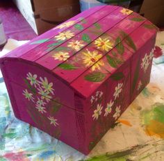 a painted wooden box sitting on top of a table