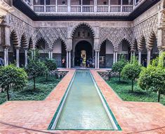 the courtyard of an old building with water running through it