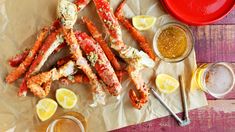 crab legs with lemon wedges and dipping sauce