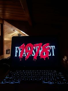 an open laptop computer sitting on top of a wooden desk with the word fappet painted on it