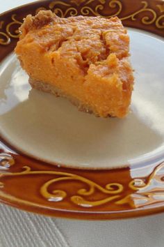 a piece of pie sitting on top of a brown and white plate next to a fork