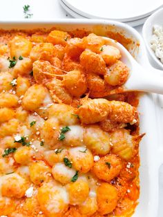 a casserole dish filled with shrimp and cheese