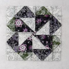 two quilted squares with purple flowers on them