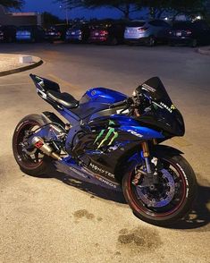 a blue motorcycle parked on the street at night