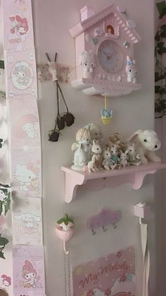 there are many stuffed animals on the shelves in this girls'room with pink wallpaper