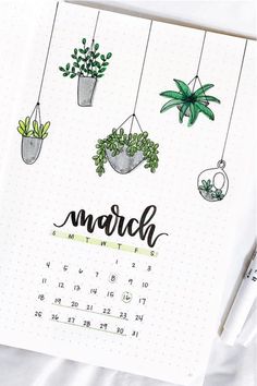 a calendar with plants hanging from it and the word march written in cursive writing