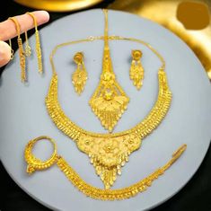 "Transform your wedding day into a breathtaking spectacle with our exquisite 22k gold-plated Indian bridal jewelry set. This stunning ensemble includes a necklace, matching earrings, a delicate nose ring, and a support chain, all meticulously designed to radiate timeless elegance. Crafted to resemble the richness of 1-gram gold Indian jewelry, this collection is the epitome of opulence without the hefty price tag. Make a statement on your special day with the allure of traditional Indian design Gold Indian Jewelry, Indian Jewelry Set, Bride Indian, Indian Bridal Jewelry Sets, Necklace Matching, Indian Jewelry Sets, Bridal Jewellery Indian, Short Necklace, Bridal Jewelry Sets