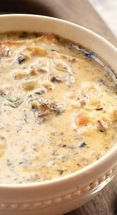 a bowl of soup sitting on top of a wooden table