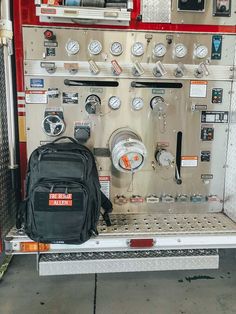 a backpack is sitting on the back of a firetruck's control panel