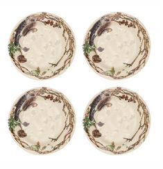 four white plates with trees and leaves on them