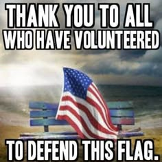 an american flag sitting on top of a wooden bench next to the ocean with text that reads, thank you to all who have volunteered to defend this flag