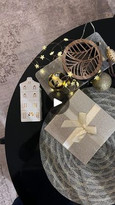 a table topped with gifts and decorations on top of a black tablecloth covered in gold stars