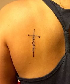 a woman with a tattoo on her back saying faith