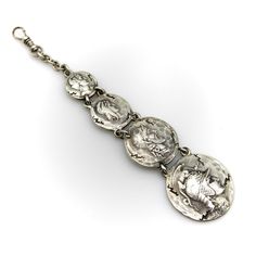 This is part of Chairish’s Costume Jewelry assortment.  This sterling silver fob features four graduated homeric medallions, dangling from a dog clip. Designed by George Shiebler, circa 1890’s, the piece was originally a watch fob; in contemporary use it makes a dramatic pendant when worn on a chain, or is great for a modern day watch enthusiast. The medallions are hand-hammered, with an ancient and cracked look to them—meant to make the piece look like it had come out of the many archaeological Historical Silver Medallion Jewelry, Dog Clip, A Dog, Costume Jewelry, Sterling Silver, Chain, Pendant, Silver