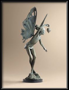 a statue of a fairy holding a flower