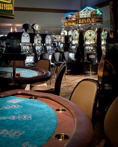 a casino room filled with lots of tables and chairs