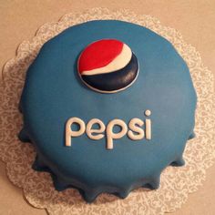 a pepsi bottle cap cake with the word pepsi on it