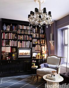 a living room filled with furniture and a chandelier