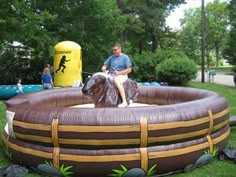 a man riding on the back of a horse in an inflatable pool