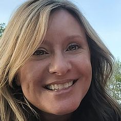 a close up of a woman smiling for the camera