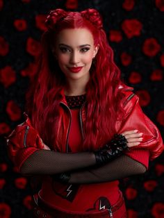 a woman with long red hair and black gloves posing for a photo in front of roses