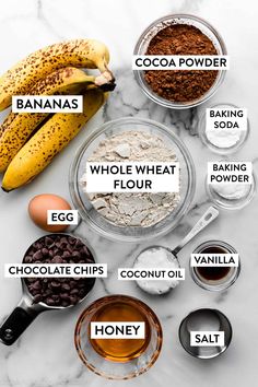 ingredients to make chocolate peanut butter banana bread on a marble countertop with bananas and flour