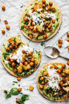 three flatbreads topped with chickpeas, avocado and sour cream