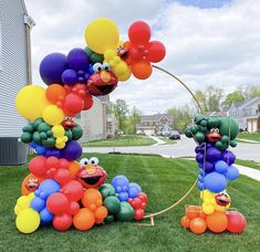 the balloon arch is decorated with balloons and sesame street characters, as well as other decorations