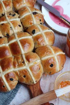 hot cross buns on a cutting board with honey