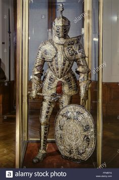 an armor and helmet on display in a glass case