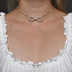 The cutest bow necklace you ever did see. Featuring an adorable mini bow in the center adorned by delicate pearls floating around your neck. Handcrafted using high quality genuine freshwater pearls and 14k gold-filled hardware. DETAILS. * Freshwater pearl * 14k gold-filled hardware * Gold-tone stainless steel wire * Lobster clasp with 3" extender chain * Bow measures approx. 1.75" x 1" * Model wearing at 15" length If you want a custom size, please message me. PLEASE NOTE. Freshwater pearls are Pearl Bow Necklace, Ribbon Knot, Illusion Necklace, Cute Gifts For Her, Floating Necklace, Jamais Vu, Mini Bow, Pearl Bow, Bow Necklace