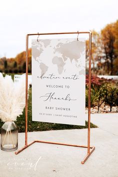 a welcome sign for a baby shower is shown in front of a planter with pamylons