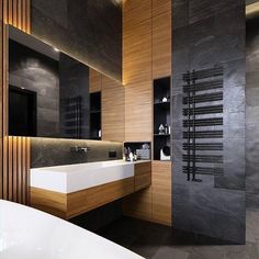 a modern bathroom with black and wood accents