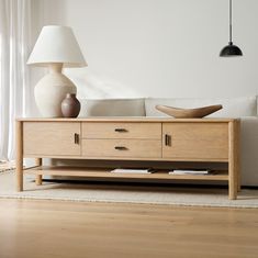 a living room scene with focus on the coffee table and sideboard in the foreground