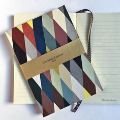 two notebooks with different colored papers next to each other