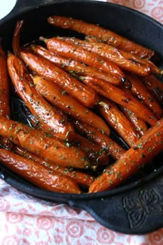 a pan filled with cooked carrots on top of a table